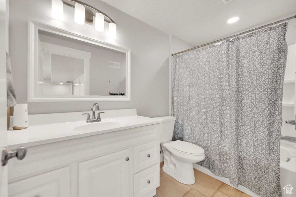 Full bathroom with toilet, vanity, shower / bath combo, tile patterned flooring, and recessed lighting