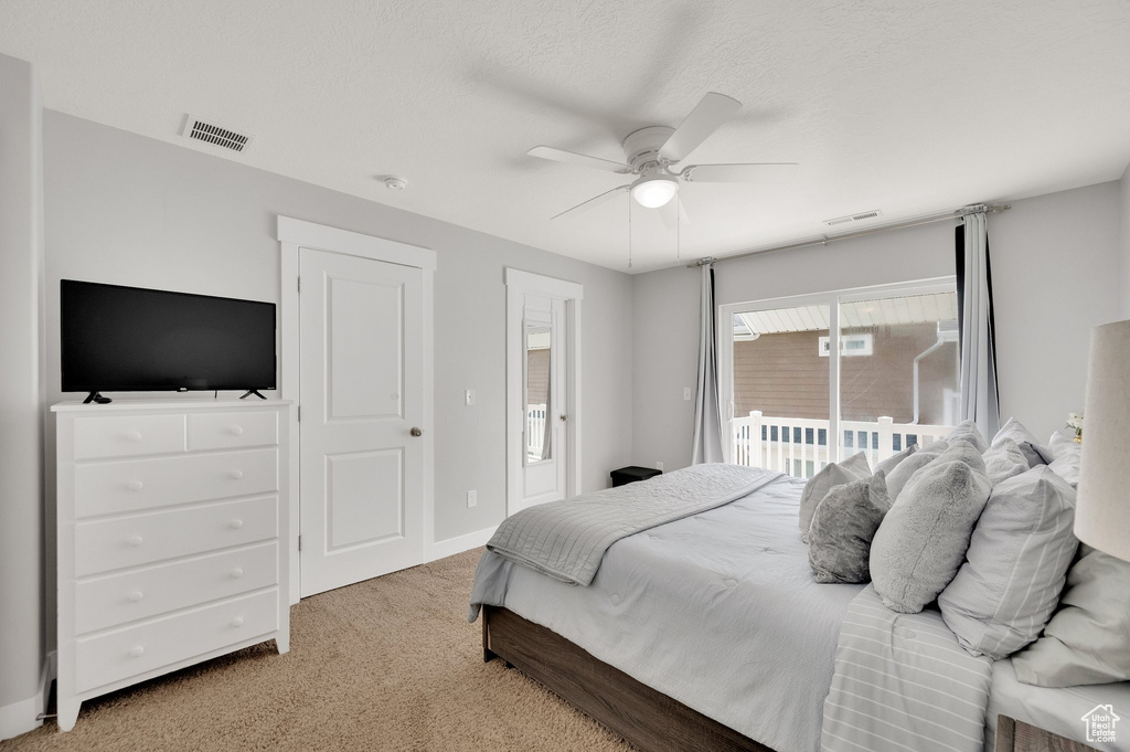 Bedroom with carpet floors, access to exterior, a ceiling fan, and baseboards