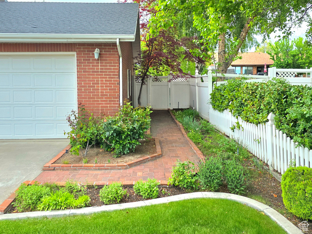 View of yard with fence and a garage