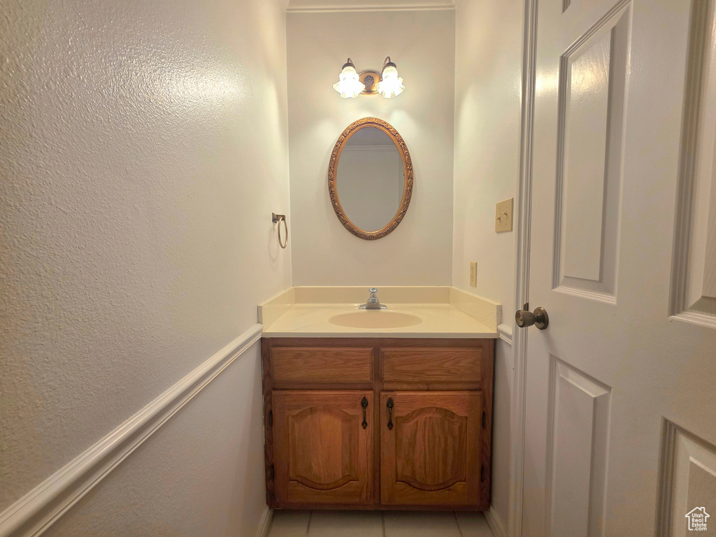 Bathroom with vanity, tile patterned floors, and baseboards