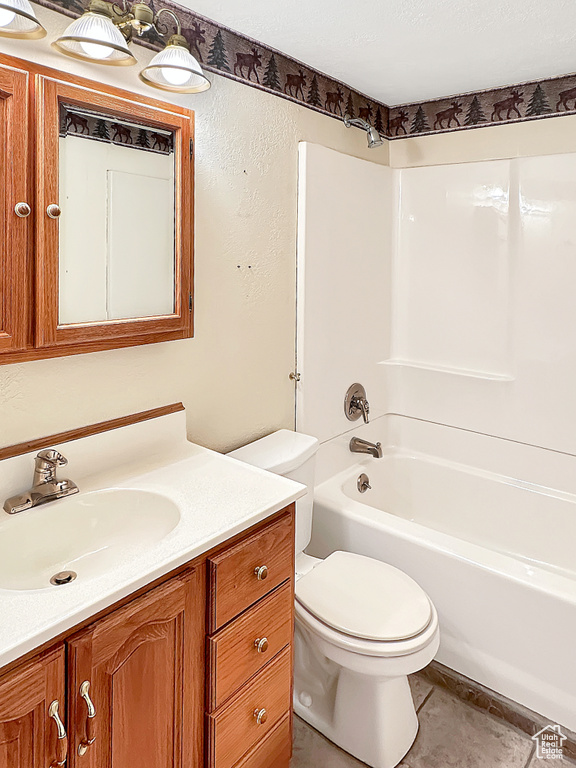 Full bath with toilet, vanity, and  shower combination