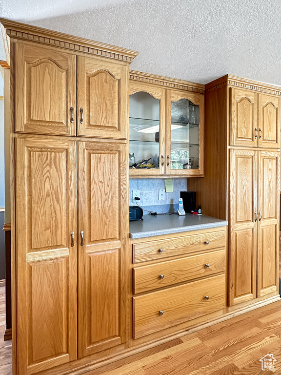 Detailed view of wood finished floors and a textured ceiling