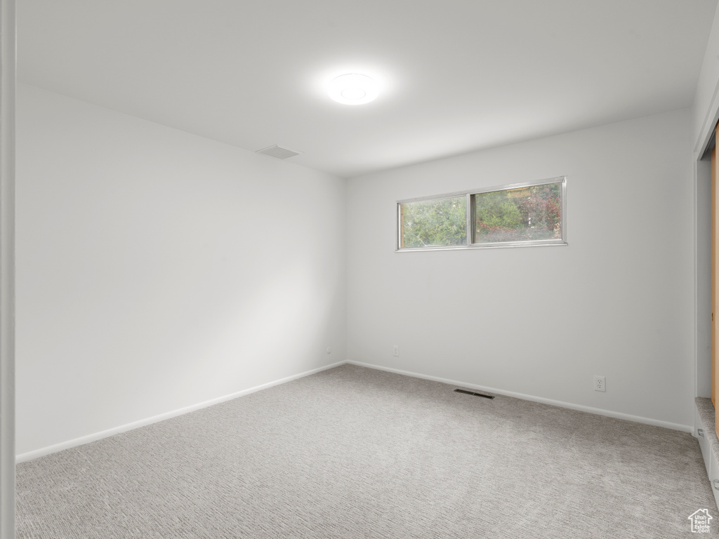Unfurnished room featuring carpet floors and baseboards
