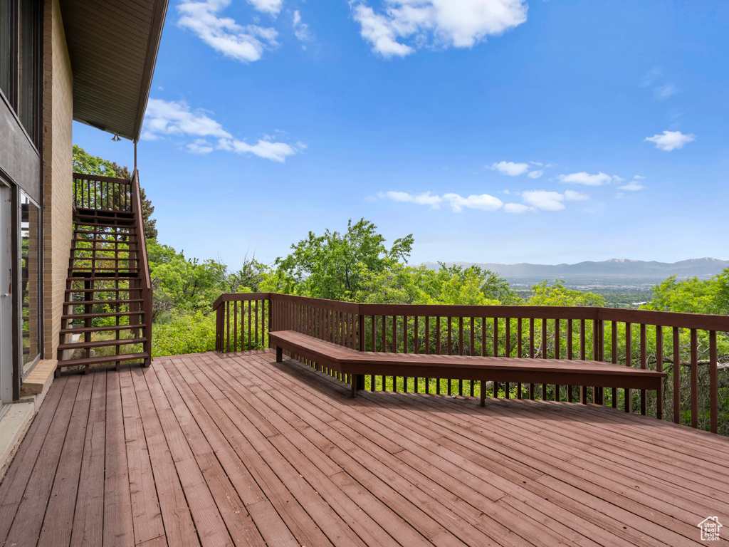 Wooden deck with stairs and a mountain view