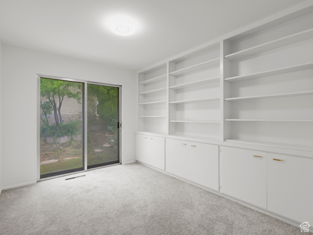 Unfurnished room featuring light colored carpet