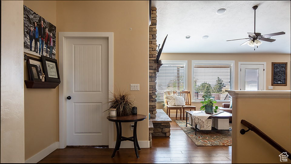 Hallway featuring hardwood / wood-style floors and baseboards