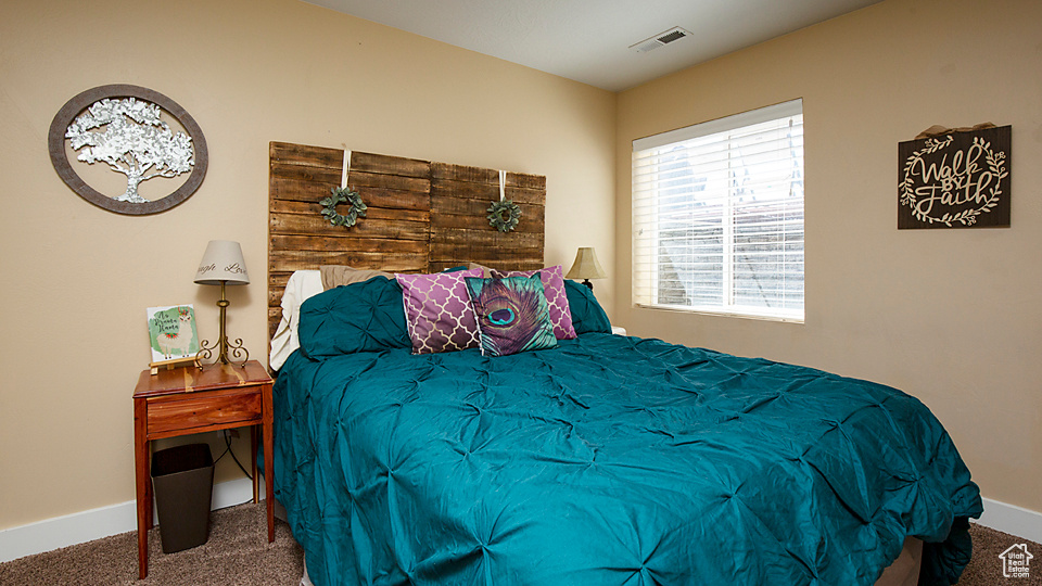 Carpeted bedroom featuring baseboards