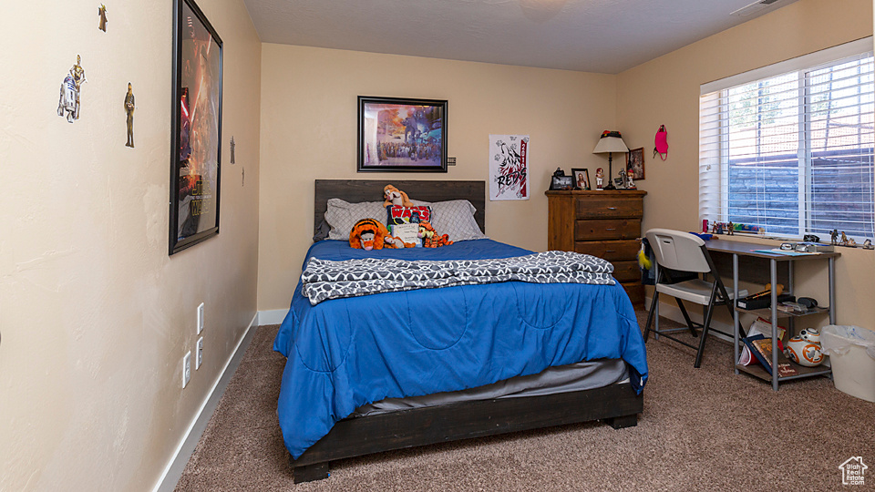Carpeted bedroom featuring baseboards