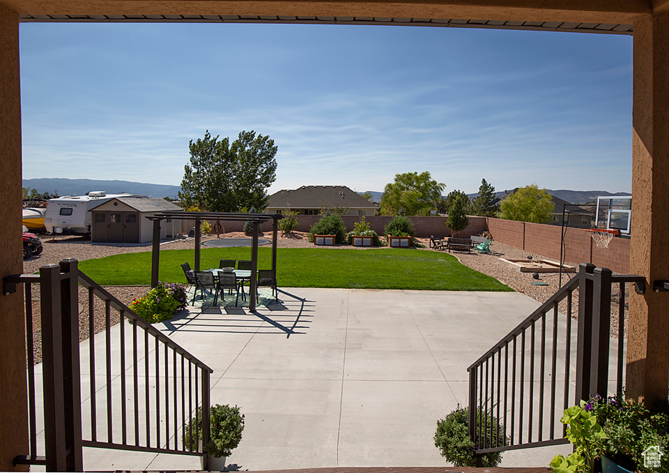 View of patio / terrace featuring an outbuilding, a storage shed, and outdoor dining area