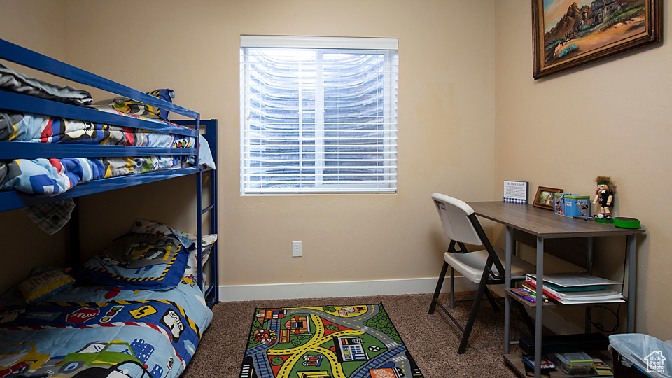 Carpeted bedroom with baseboards
