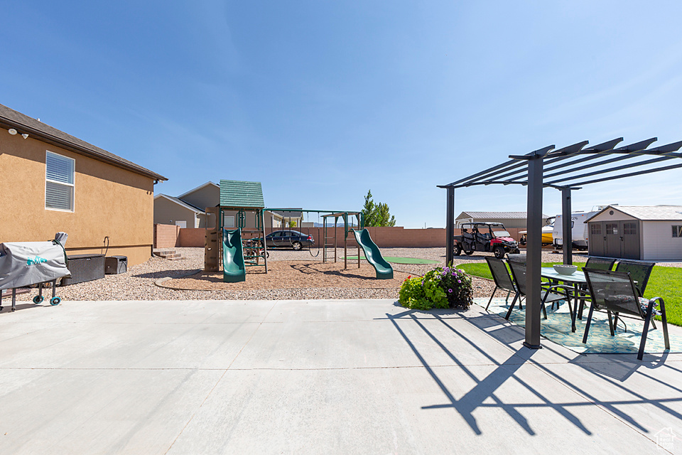 View of patio / terrace with a playground, a pergola, fence, and area for grilling