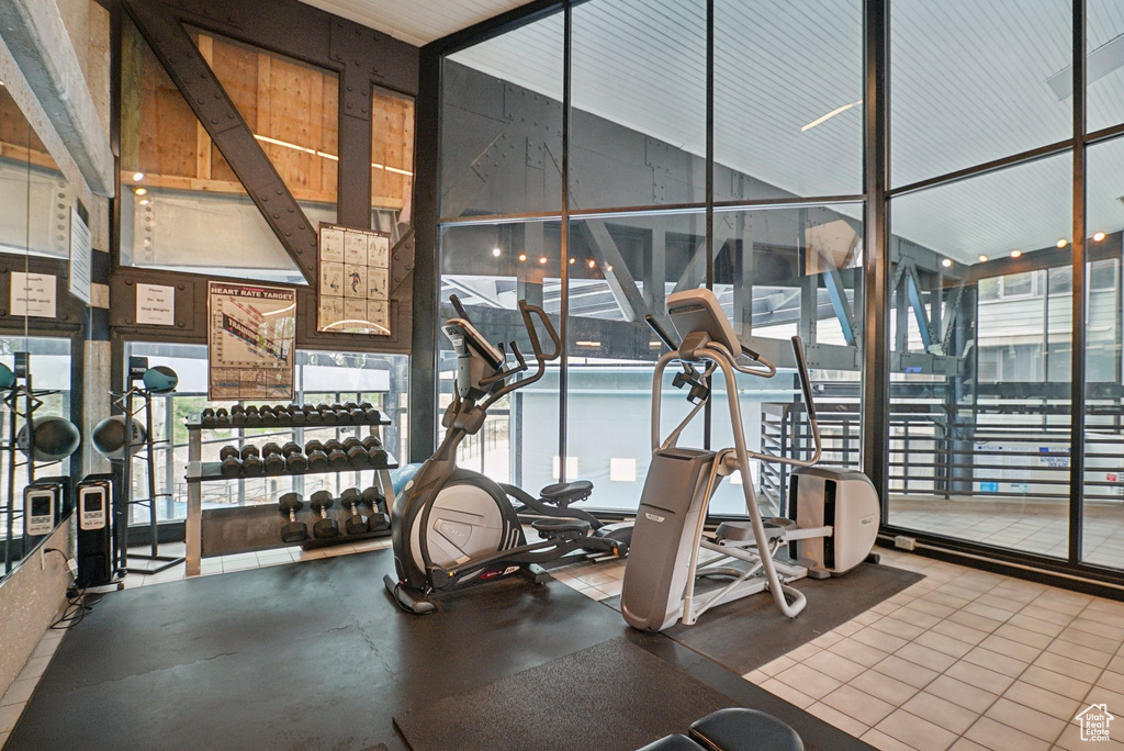 Exercise room featuring floor to ceiling windows and healthy amount of natural light