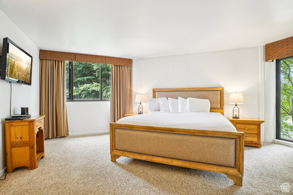 Bedroom featuring light carpet