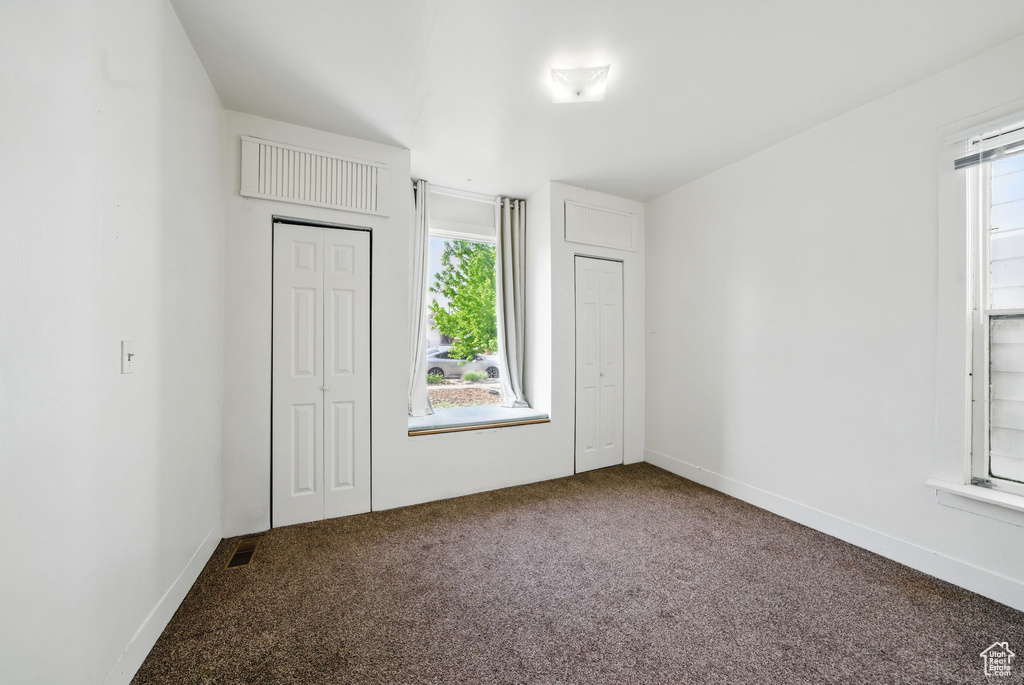 Unfurnished bedroom featuring carpet, a closet, and baseboards