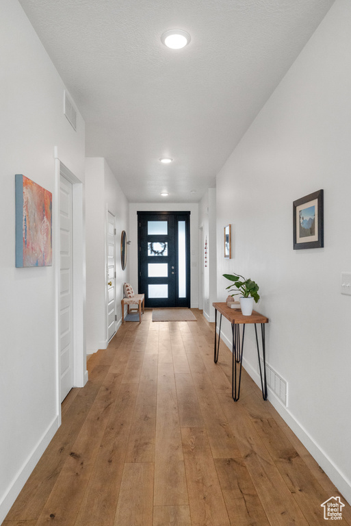 Foyer entrance with hardwood / wood-style flooring, baseboards, and recessed lighting