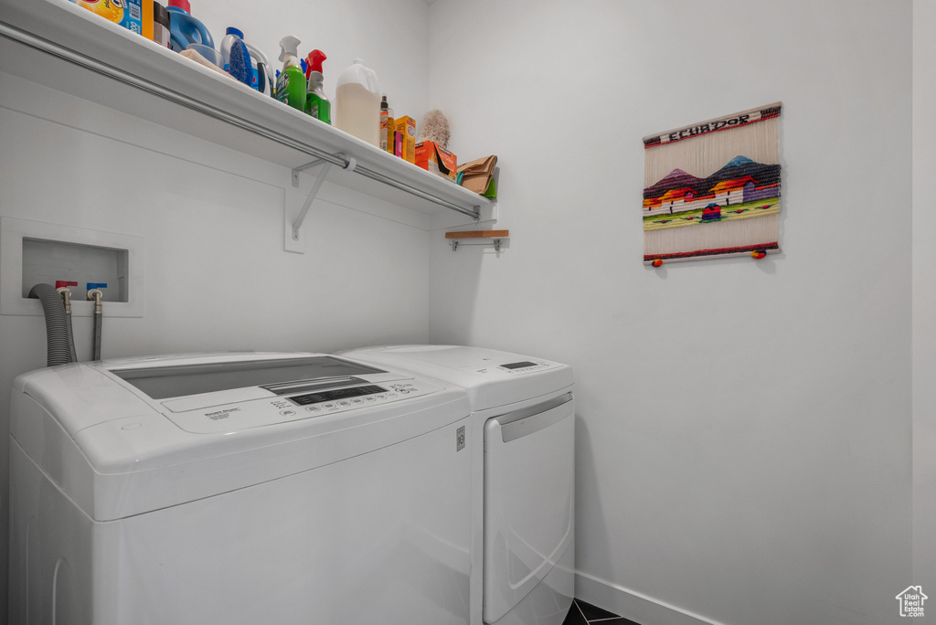 Washroom with separate washer and dryer and baseboards