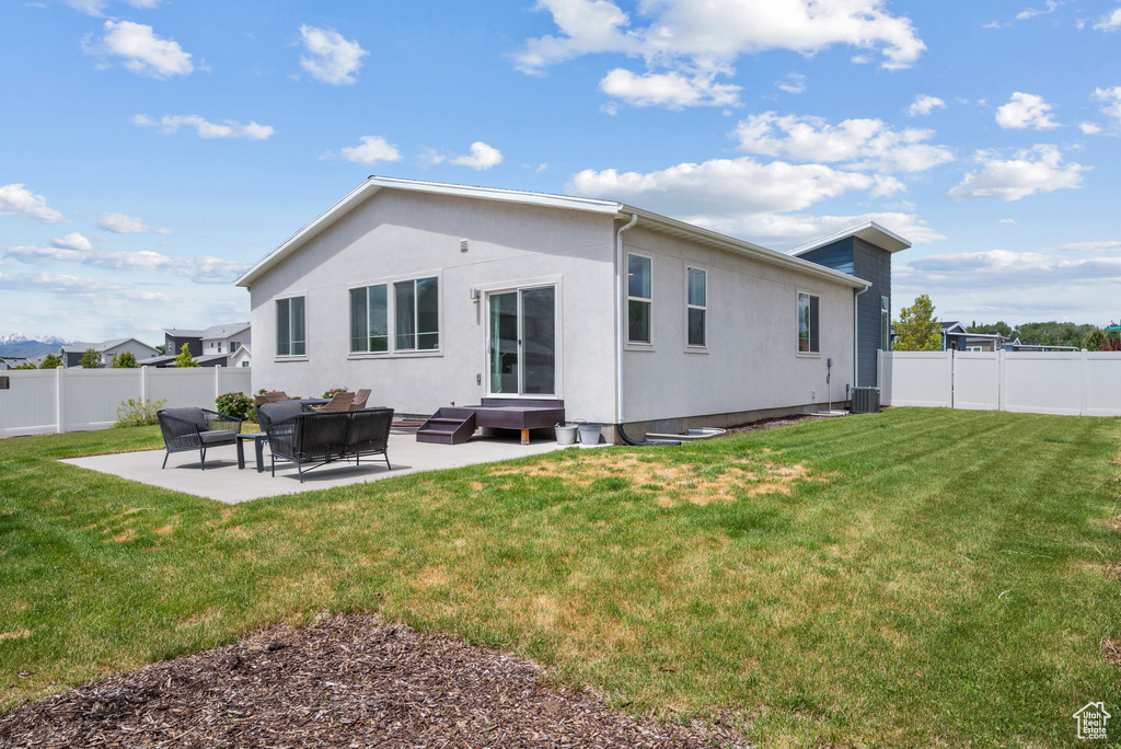 Back of property with a patio, stucco siding, and an outdoor living space