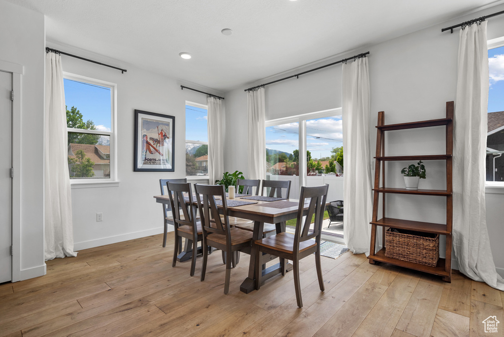 Dining area with light wood-type flooring, recessed lighting, and baseboards