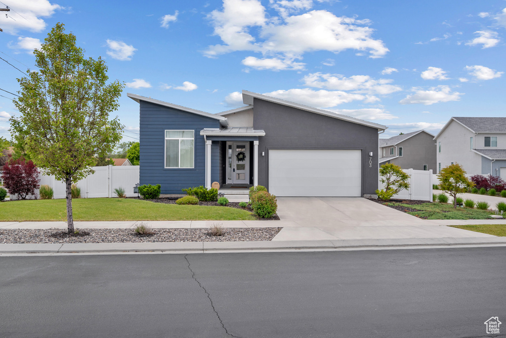 Mid-century home featuring a garage, driveway, and a residential view