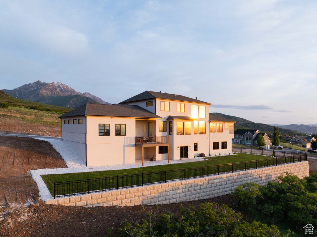 Back of house with stucco siding and a mountain view