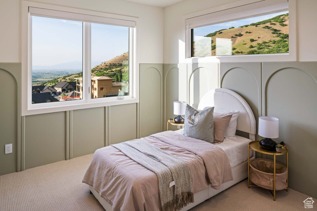 Bedroom featuring carpet and a mountain view