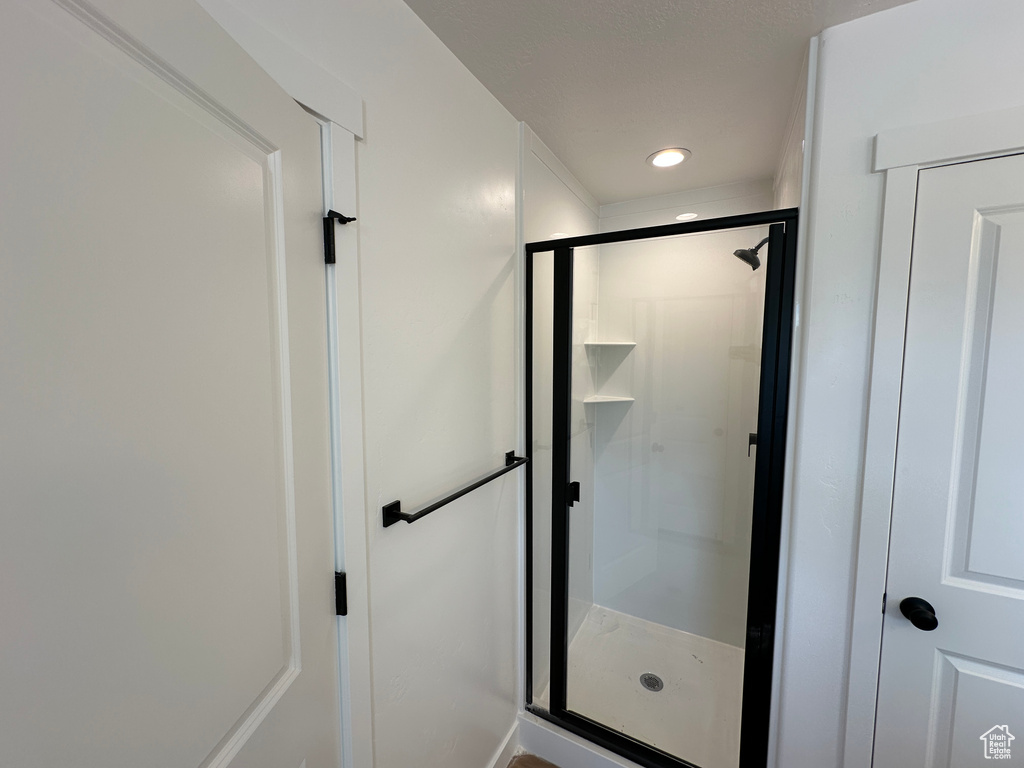 Full bathroom with a shower stall and recessed lighting