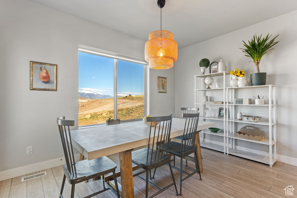 Dining space with wood finished floors and baseboards