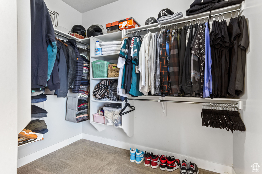 Walk in closet with carpet floors