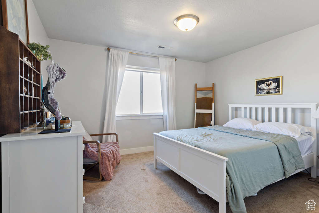 Carpeted bedroom with baseboards