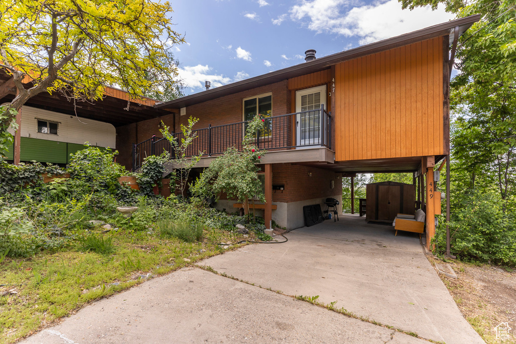 View of front facade featuring driveway and a carport