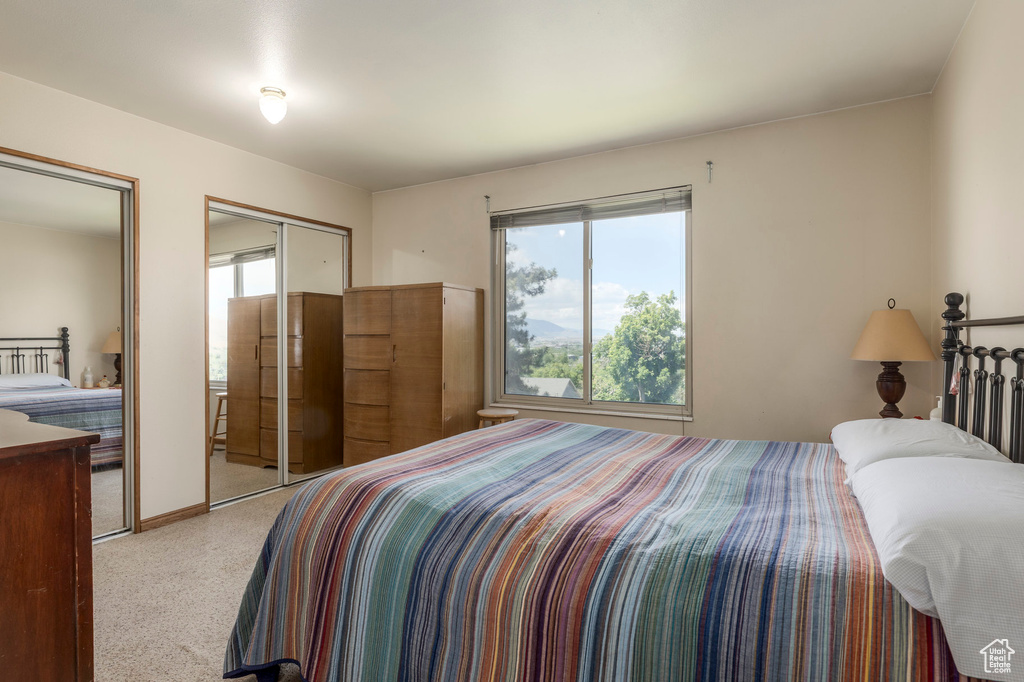Carpeted bedroom featuring two closets