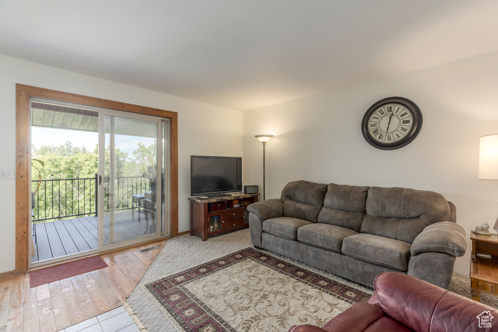 Living room featuring light wood-type flooring and baseboards