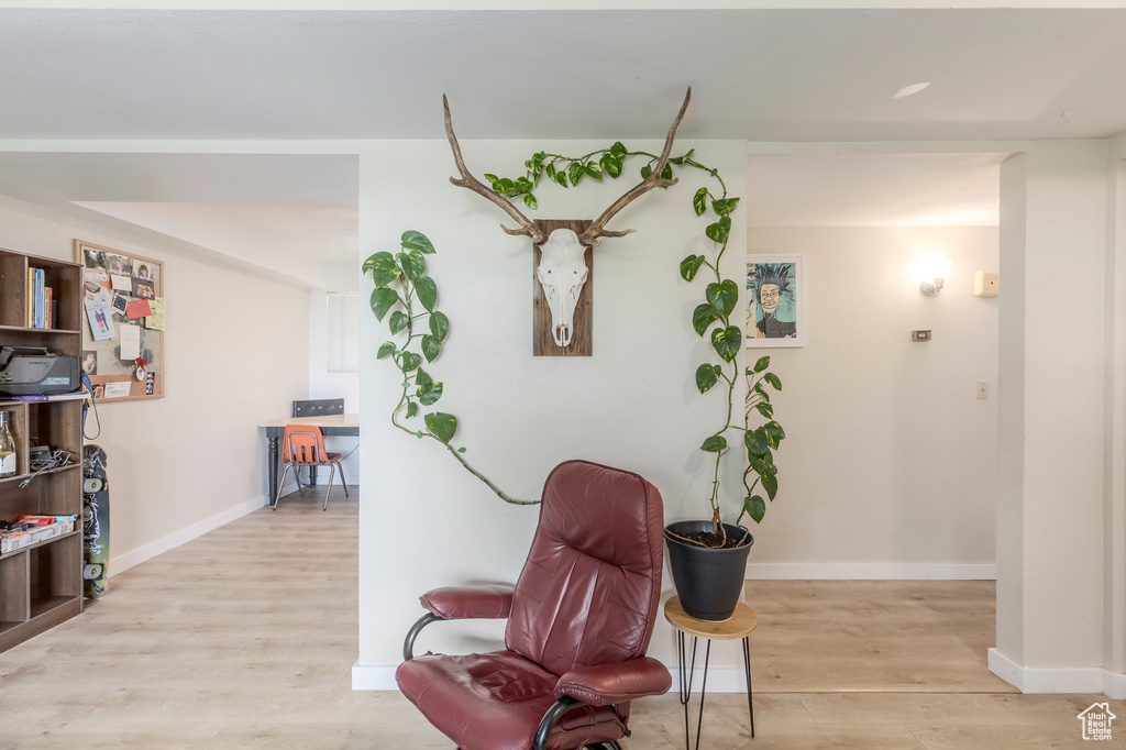 Sitting room with light wood-style floors and baseboards