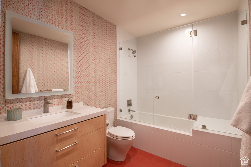 Bathroom with toilet, tiled shower / bath, vanity, tile patterned flooring, and recessed lighting