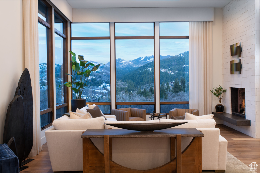 Living area featuring a mountain view, wood finished floors, and a large fireplace