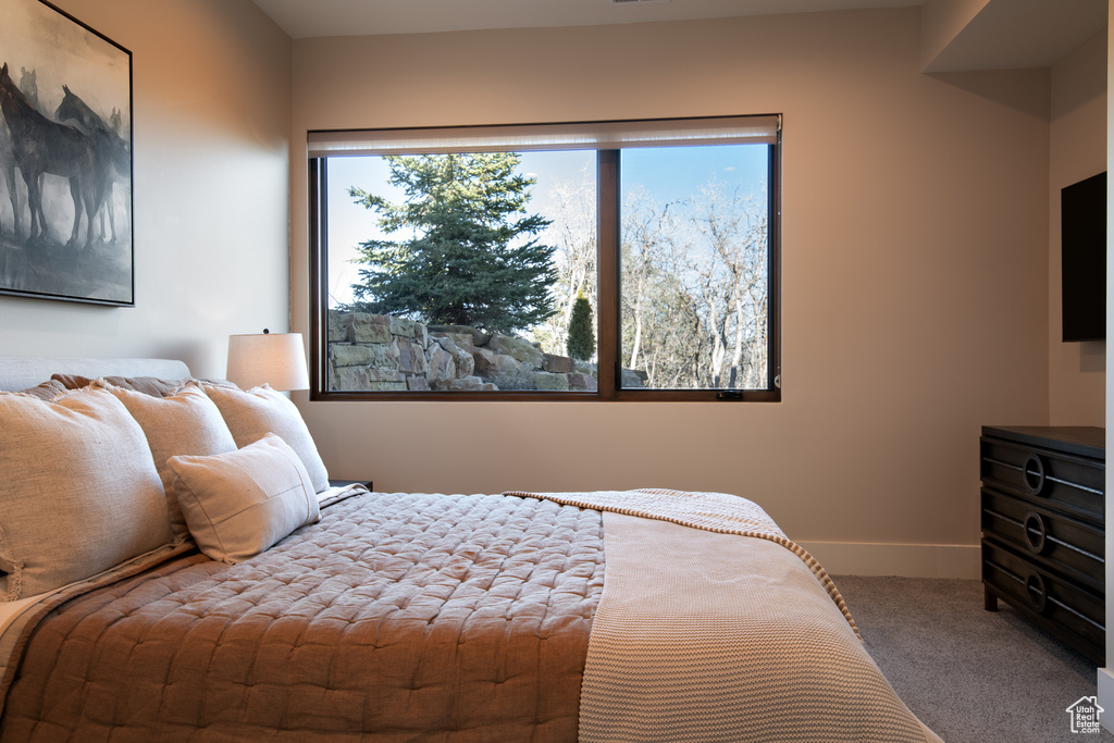Carpeted bedroom featuring baseboards