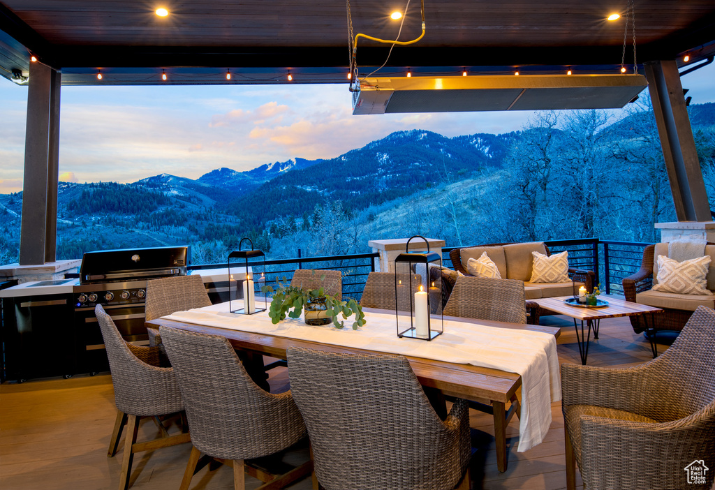 View of patio / terrace with a mountain view, an outdoor living space, grilling area, and exterior kitchen