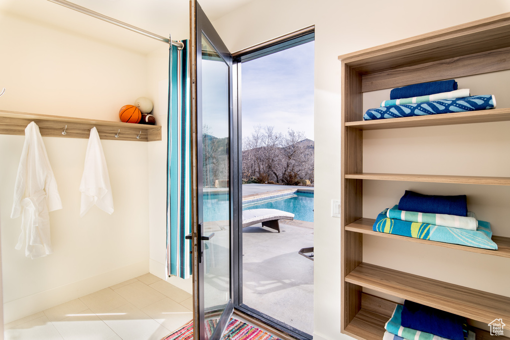 Doorway to outside featuring tile patterned flooring