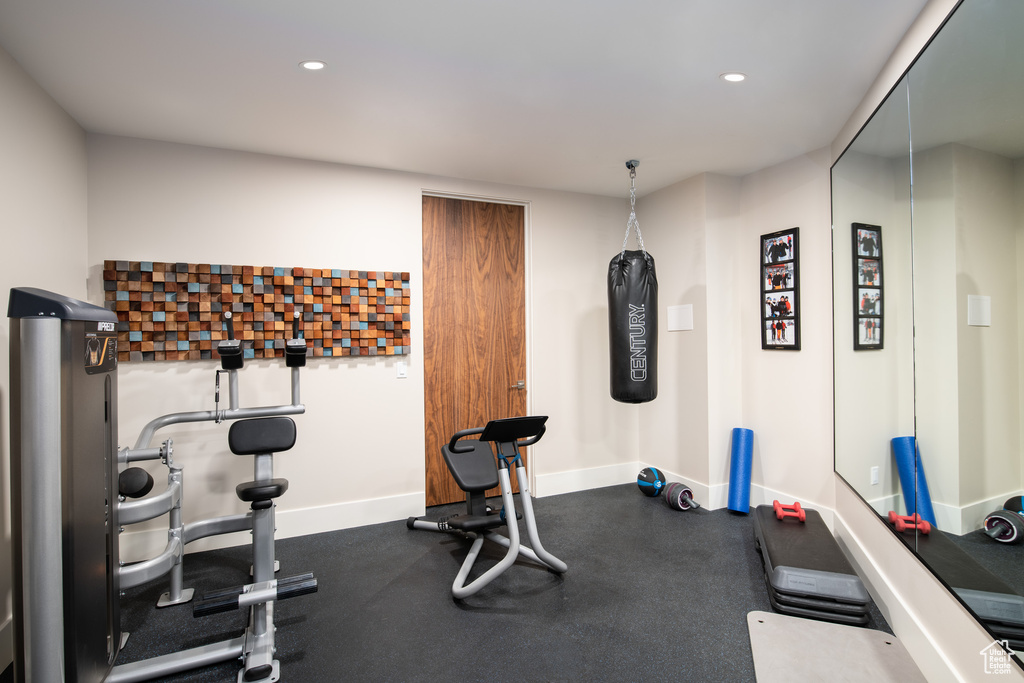 Workout area with baseboards and recessed lighting