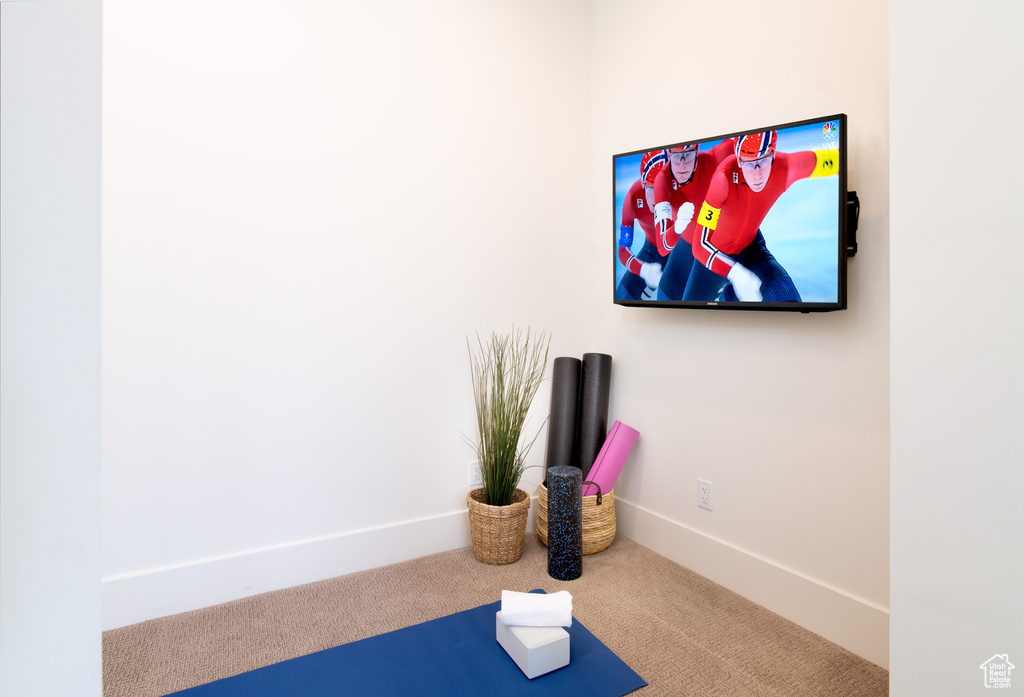 Workout room with carpet floors and baseboards