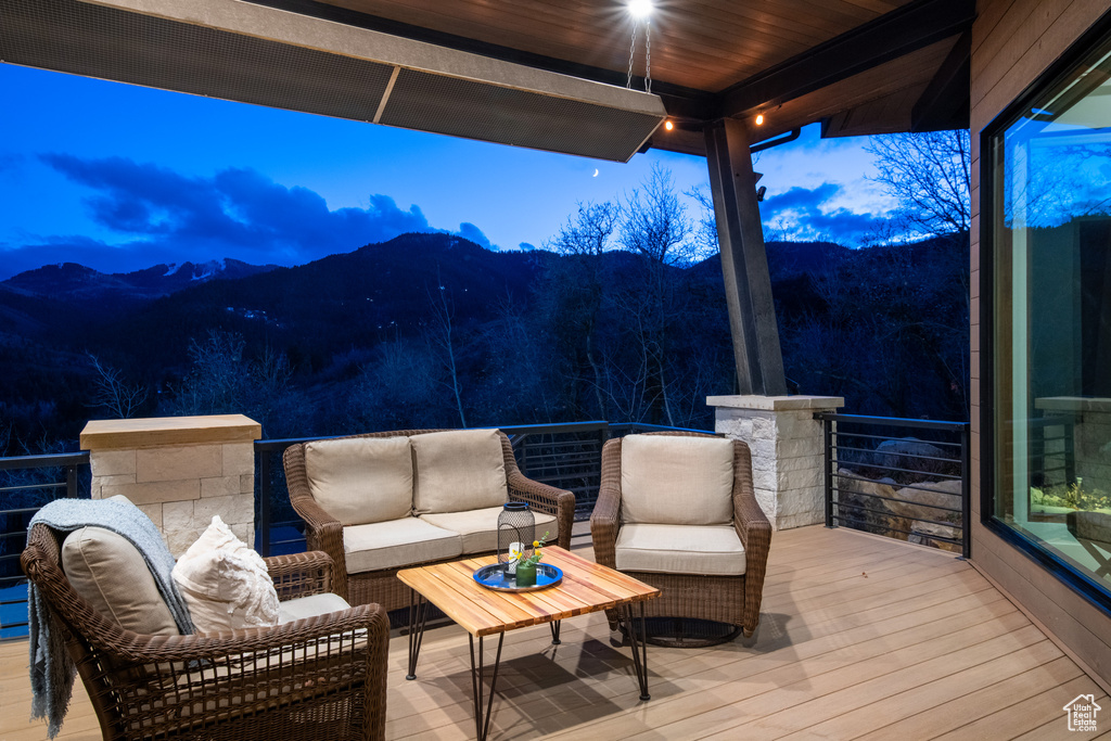 Deck with a mountain view and an outdoor living space