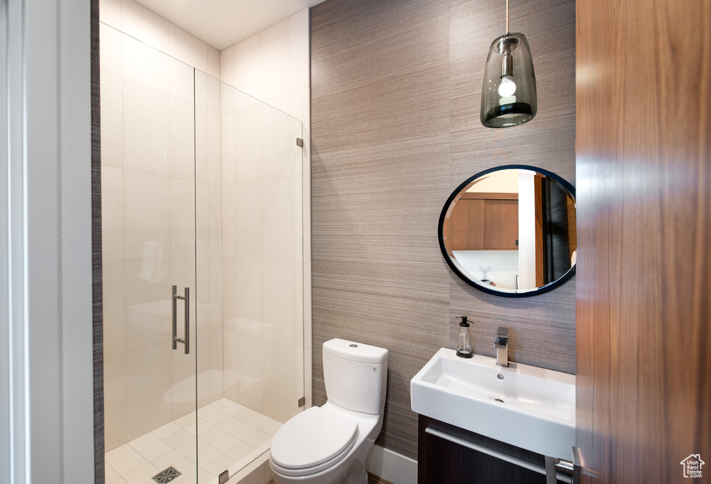 Bathroom with a stall shower, toilet, and vanity