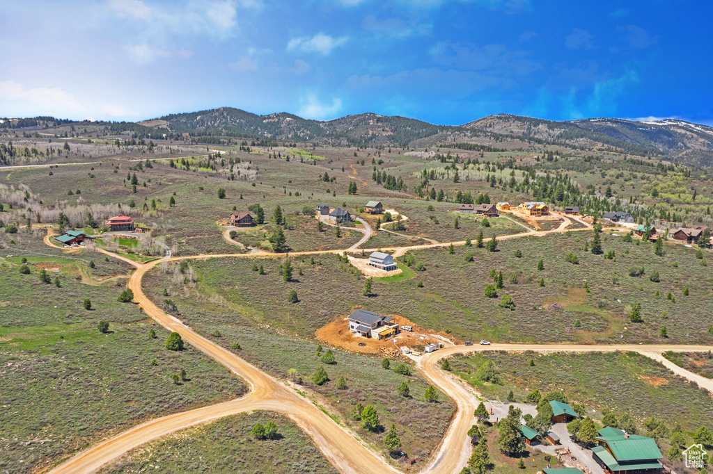 Aerial view of property and surrounding area featuring mountains and rural landscape