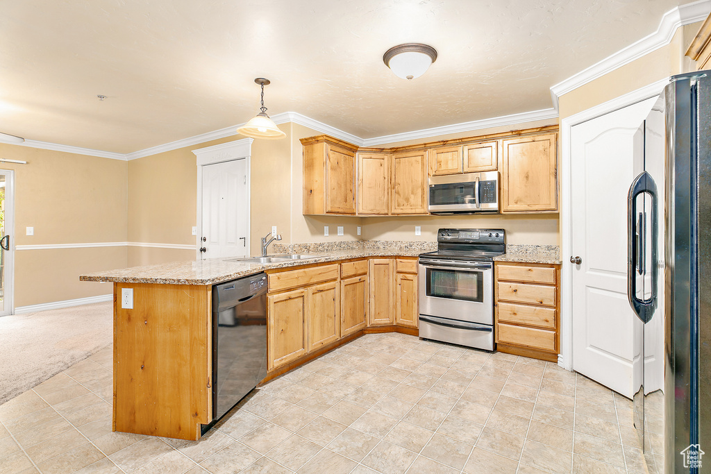 Kitchen with appliances with stainless steel finishes, a sink, a peninsula, ornamental molding, and light stone counters