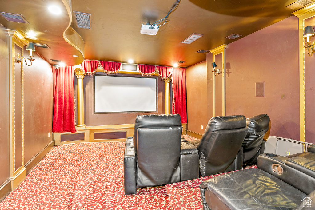 Carpeted home theater room featuring baseboards