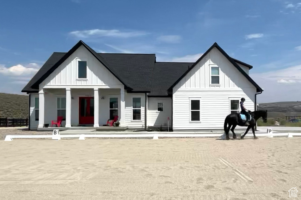View of front of house featuring board and batten siding and a porch