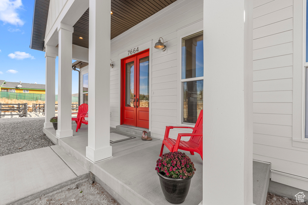 Entrance to property featuring french doors and a porch