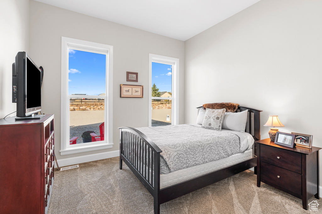 Carpeted bedroom with baseboards