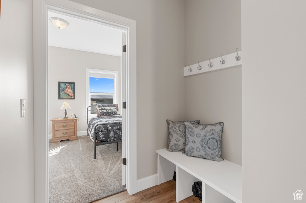 Mudroom featuring baseboards and light wood-style floors