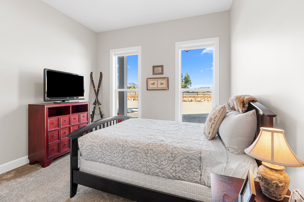 Carpeted bedroom featuring baseboards